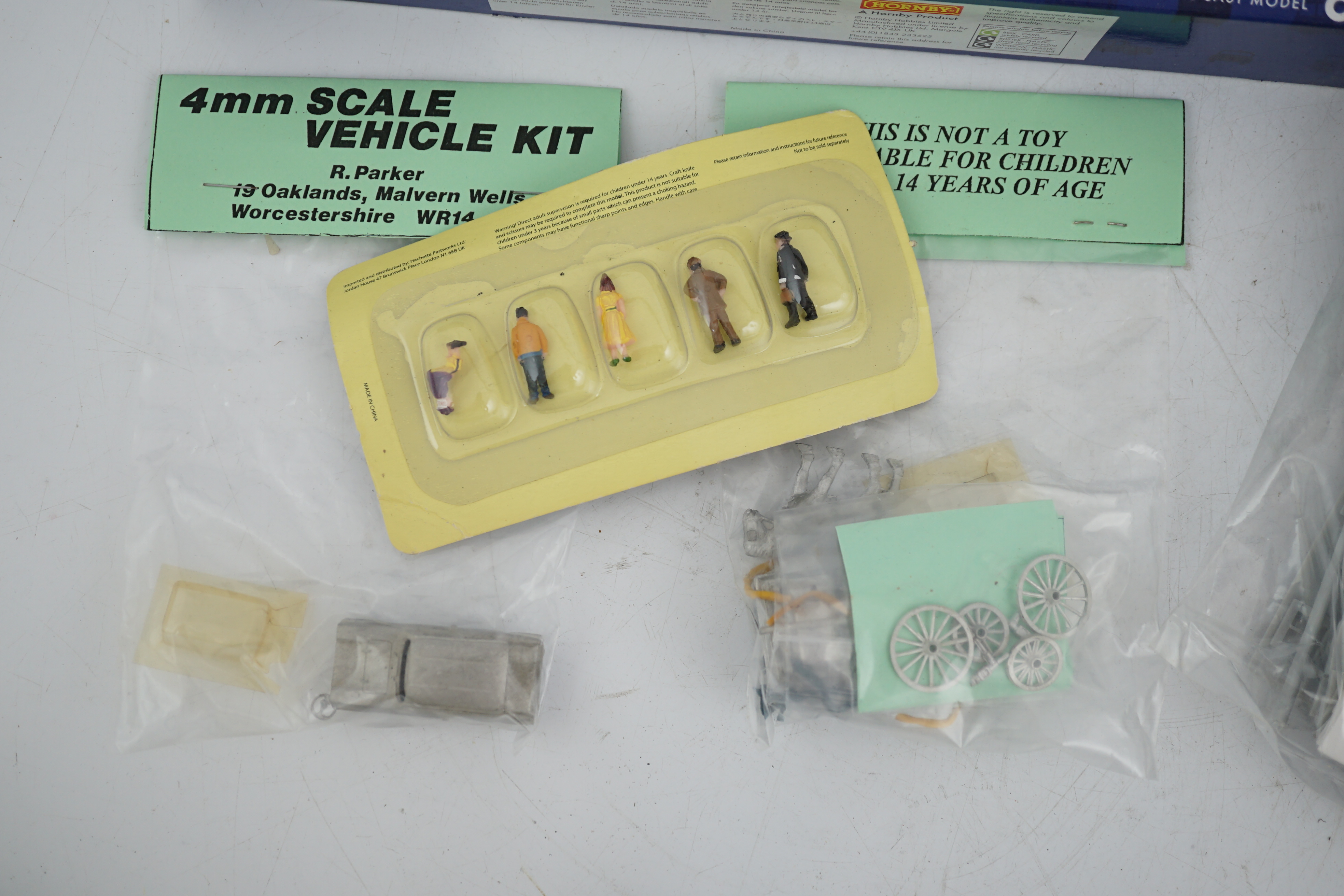 A collection of packeted white metal and plastic 00 gauge model railway kits by Dapol, 4mm Scale Vehicle kits R. Parker, etc. including diesel cranes, AEC lorries, LBSCR Stroudley 4-wheel coaches, trackside vehicles, etc